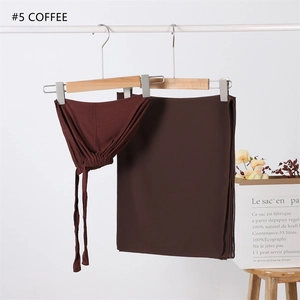 Detail of coffee brown chiffon hijab set with modal cap on wooden hanger display