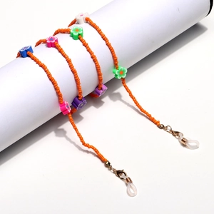 Colorful beaded eyewear strap with bright orange beads and floral charms on white stand
