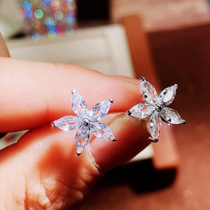 Five-petal flower stud earrings with sparkling marquise-cut clear zircons on hand