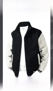 Detailed texture of thick black lamb wool fleece jacket with contrast cream sleeves