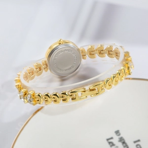 Detailed macro view of the stainless steel back of a golden mermaid bracelet watch