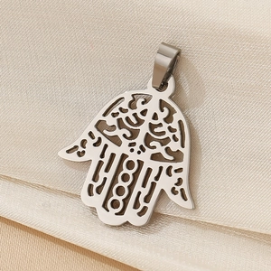 Detailed macro view of a silver Hamsa Hand pendant with intricate hollow cutouts