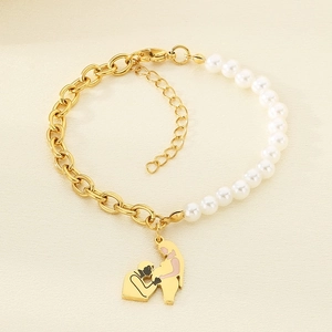 Detail of gold chain and pearl bracelet featuring a unique pregnant woman silhouette pendant