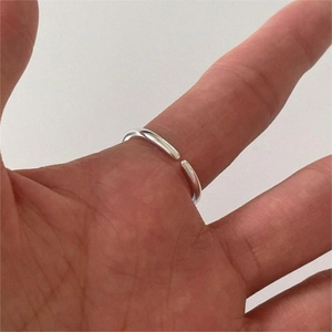 Close-up of minimalist 925 sterling silver open ring with black onyx on hand