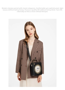 Vintage clock crossbody bag with Roman numerals worn with a brown checkered blazer