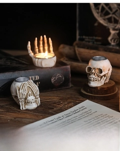 Gothic skull and skeleton hand candle holders for vintage Halloween desk decor