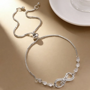 Detail of adjustable box chain bracelet with silver infinity symbol and Sister engraving