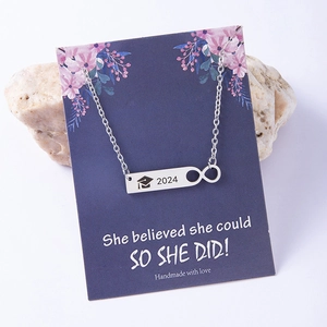 Silver 2024 graduation necklace with infinity charm on she believed she could card