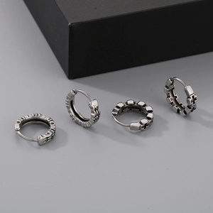 Detail showing vintage silver finish stainless steel hoop earrings with cross patterns