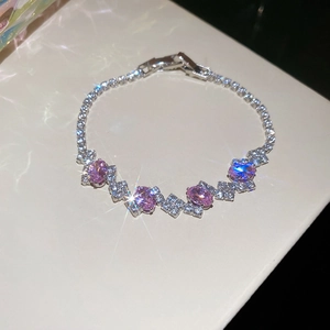 Detailed view of silver-tone bracelet featuring four pink oval zircons with folding clasp