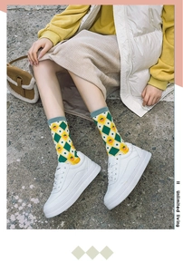 Street style view of mid-calf cotton socks with strawberry and argyle patterns and sneakers