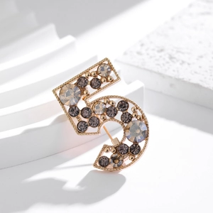French vintage style gold number 5 brooch featuring luxury rhinestones on white stone