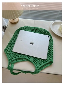 Close-up of green crochet tote bag showing spacious interior with an iPad for scale