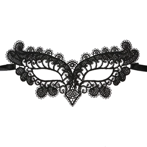 Close-up of black lace eye mask with intricate hollow patterns and ribbon ties
