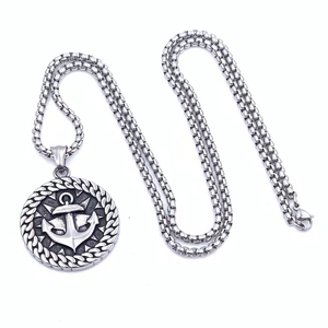 Close-up of vintage silver viking anchor pendant with nautical rope texture on box chain