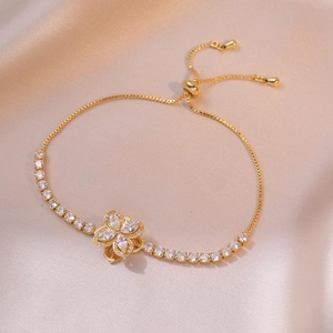 Detail of adjustable gold flower bracelet with sparkling marquise-cut zircon stones