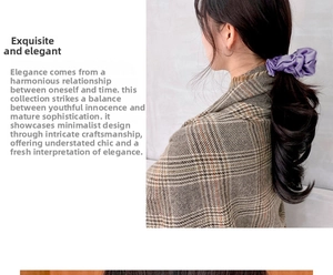 Detail of purple satin scrunchie made of glossy silk-like fabric with elegant pleats