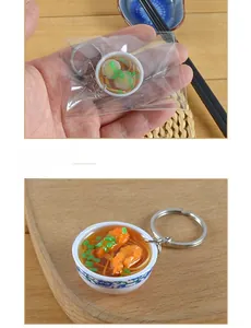 Close-up of miniature blue and white porcelain bowl noodle keychain with shrimp detail
