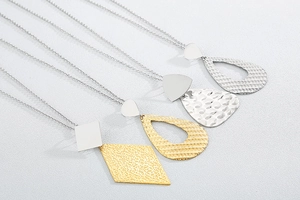 Detailed view of long titanium steel necklaces with diamond and teardrop pendants