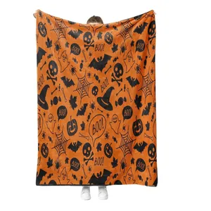 Halloween flannel blanket featuring orange pumpkin and ghost cartoon prints