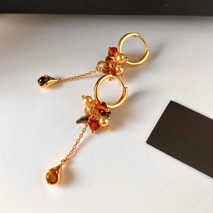 Vintage gold hoop earrings with pearls, tiger eye stones, and elegant chain tassels