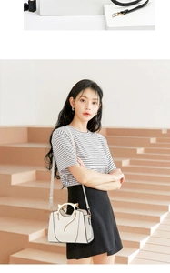 Chic white PU leather handbag featuring stylish gold metal cat-ear shaped top handles