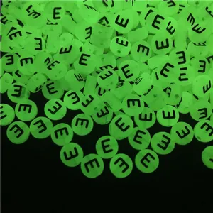 Macro detail of glow-in-the-dark acrylic letter beads for DIY jewelry making in darkness