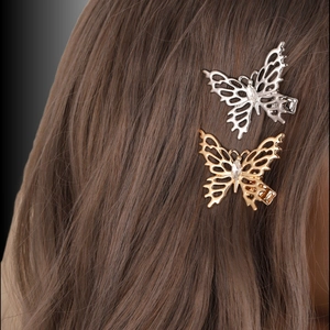 French style hollow butterfly hair clips in gold and silver on brunette hair