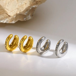 Macro view of gold and silver stainless steel ear cuffs with rhinestone accents.