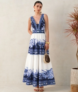 Detail of Mediterranean blue floral print on deep V-neck maxi dress with tiered skirt