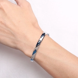 Polished silver and blue titanium steel magnetic bracelet for men on a wrist
