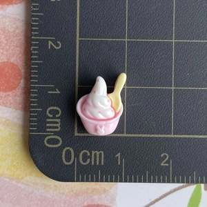 Detailed view of miniature resin strawberry ice cream cup showing precise 1.5cm size scale