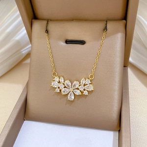 Detailed close-up of a luxury gold-plated flower pendant necklace with zircon crystals