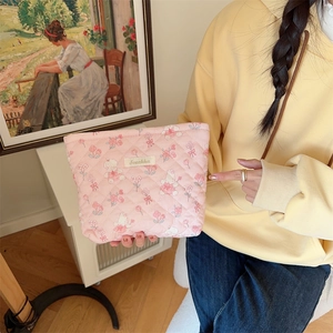 Close-up of pink quilted makeup bag with tulip bunny prints and Sorakka brand label
