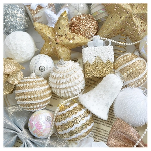 Flat lay of champagne gold and silver Christmas ornaments on vintage paper