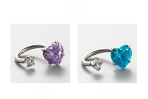 Detail showing titanium steel horseshoe ear studs with sparkling purple and blue heart zircons