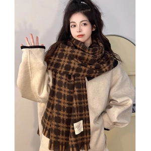 Brown and black plaid scarf with fringe and vintage Paris label on model