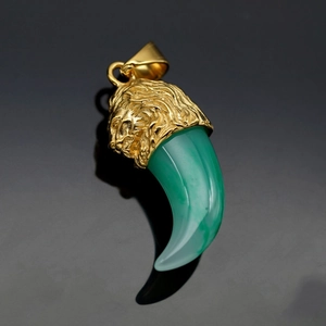 Gold-plated hip hop lion head pendant with a green translucent faux wolf tooth gemstone