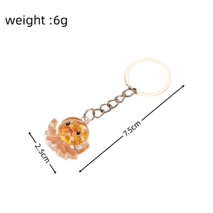 Detailed view of an orange octopus acrylic keychain with gold glitter and size dimensions