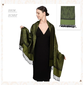 Detail of green paisley cashmere scarf showing fringe and elegant wrap style for women