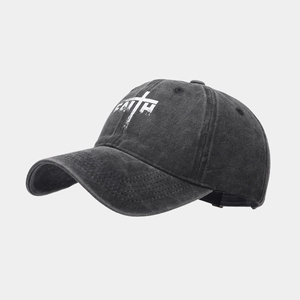 Detail of washed grey baseball cap featuring a white FAITH cross print and retro fabric