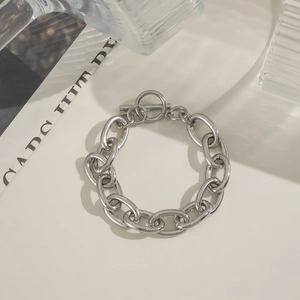 Detailed close-up of a silver stainless steel chunky chain bracelet with an OT toggle clasp
