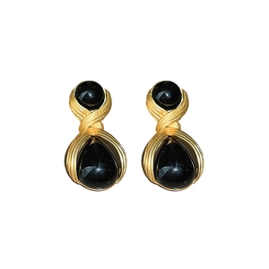 Vintage gold textured earrings with black drop shaped resin inlay and silver needle post