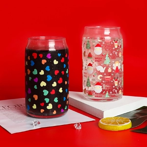 Close-up of temperature sensitive color changing glass cans with festive holiday prints
