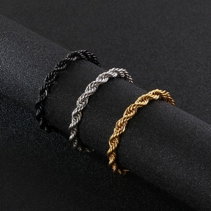 Macro detail of 6mm twisted rope chain rings in gold, silver, and black stainless steel