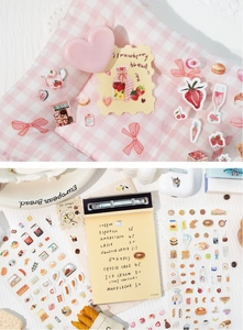Detail showing hand-drawn dessert stickers and heart shapes on pink plaid fabric