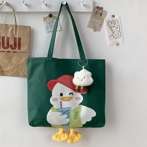 Detail view of dark green canvas tote with cute duck print and plush webbed feet