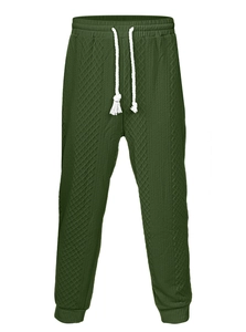 Close-up of dark green waffle knit joggers with drawstring waist and ribbed cuffs