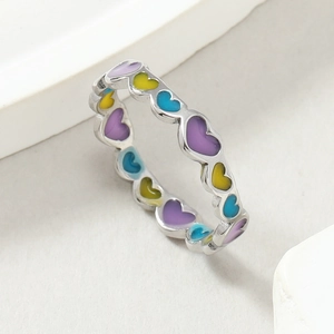 Macro detail of colorful heart enamel inlay on silver titanium steel ring for women