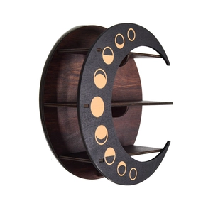 Detail of wooden crescent moon display shelf with golden moon phase patterns on side